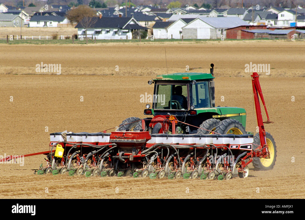 A tractor pulling a seed corn planter. Stock Photo