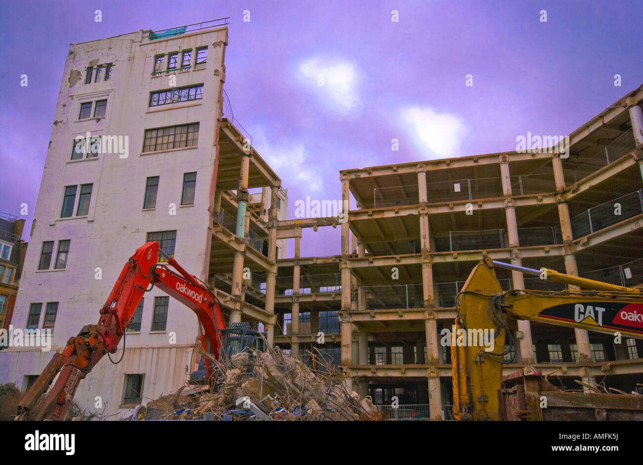 A Building being demolished using heavy machinery in London 1 of 2 Stock Photo
