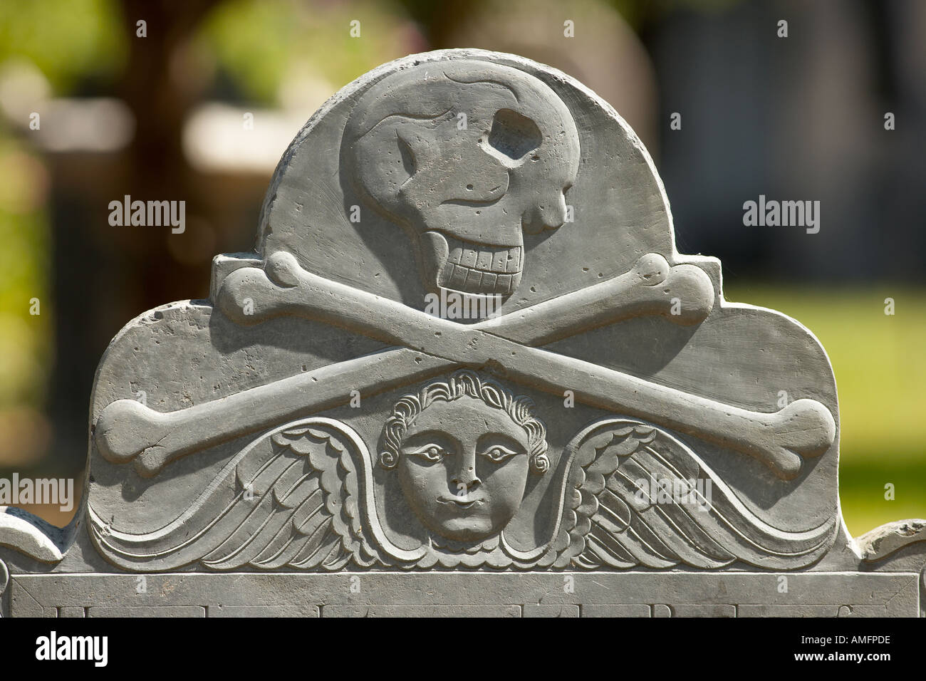 Grave stone with skull and bones Stock Photo