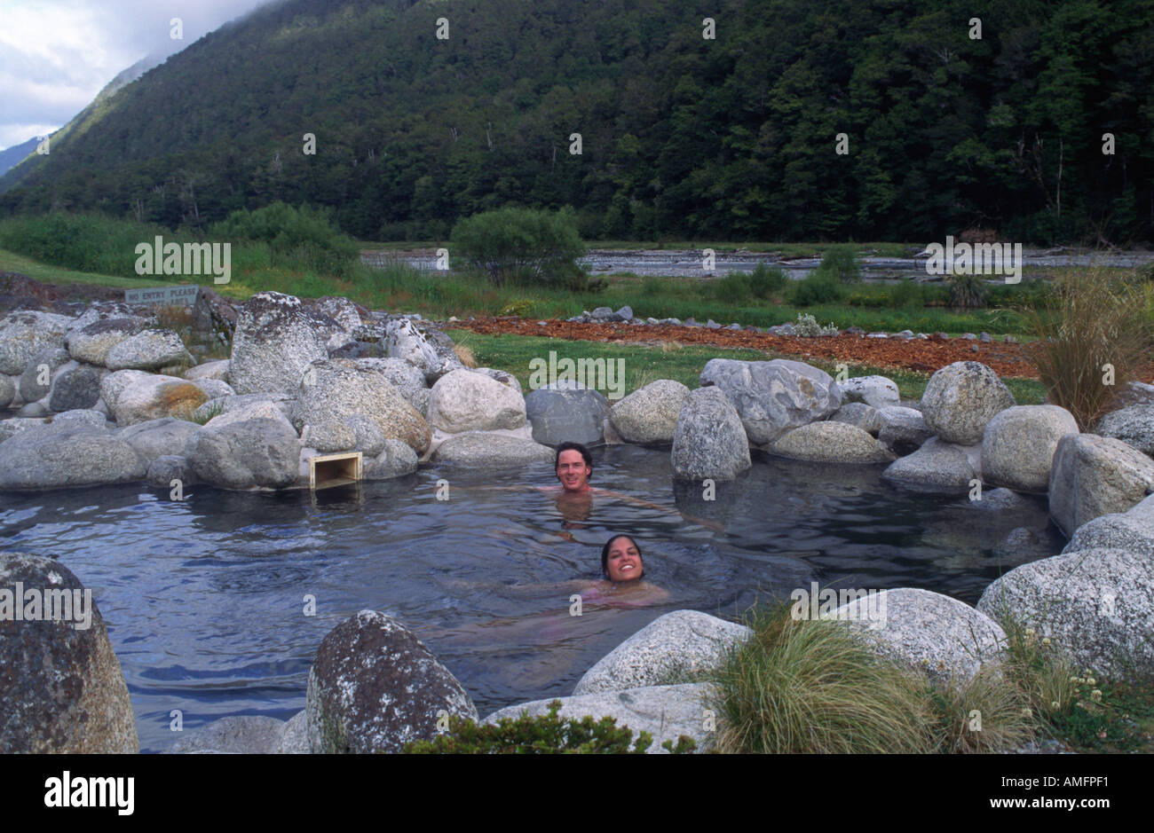 RICHARD SUJI enjoy the outdoor baths of MARUIA HOT SPRINGS located on HY 7 SOUTH ISLAND NEW ZEALAND Stock Photo