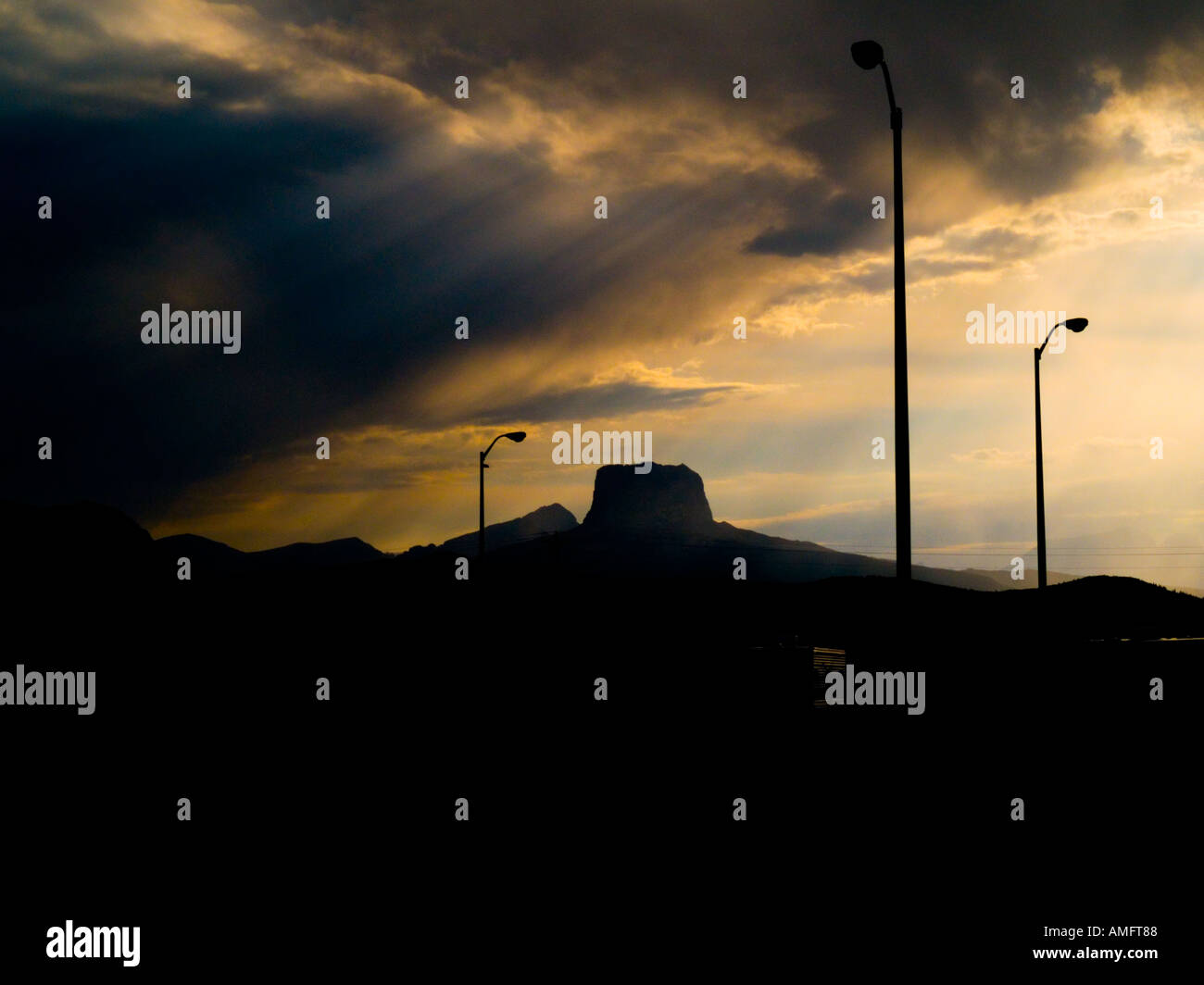 The sun streaming through the bleak looking clouds in front of Chief