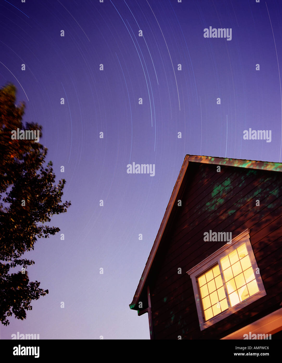 Five hour exposure of house with startrails in sky Stock Photo
