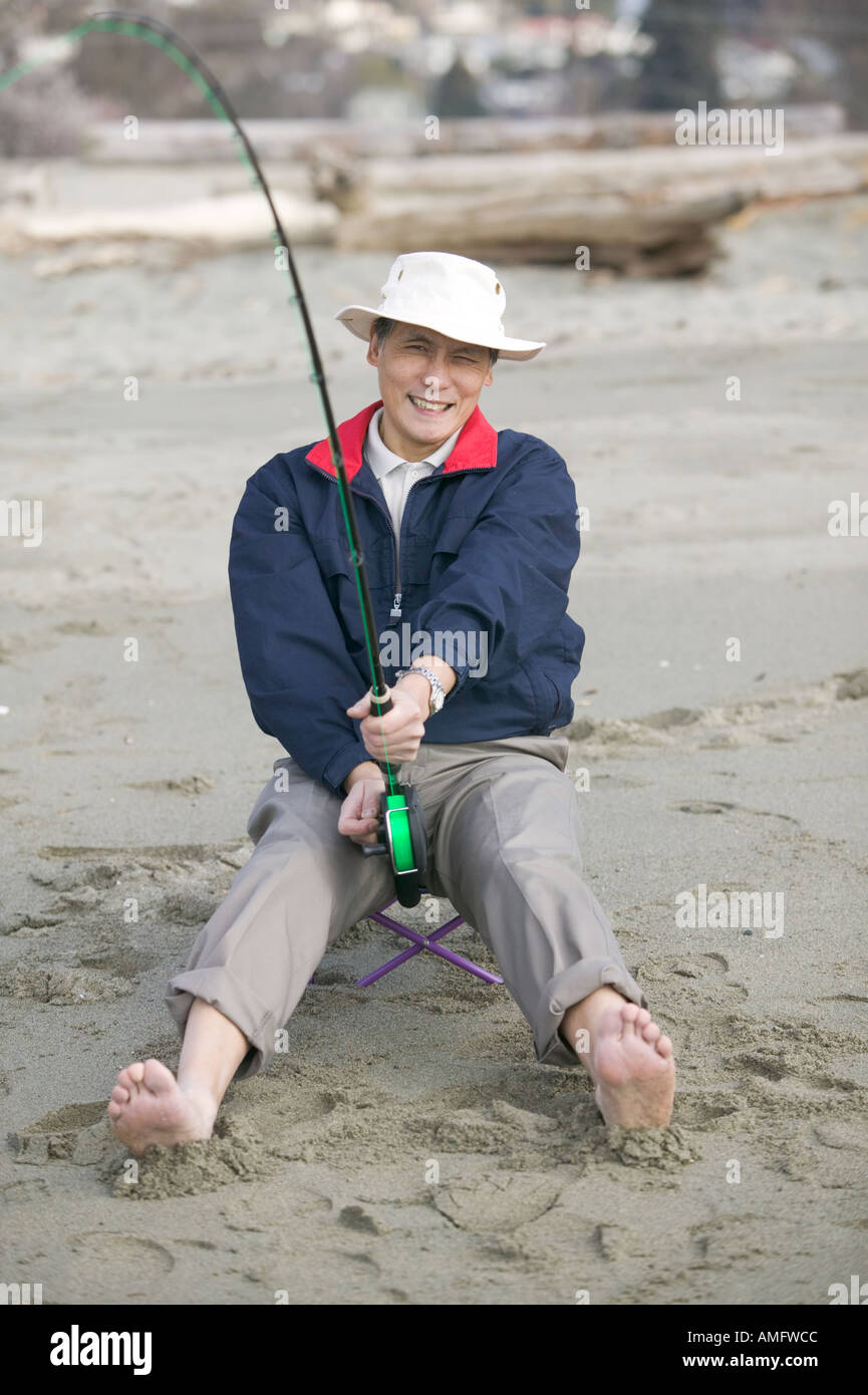 Senior Asian man fishing Stock Photo - Alamy