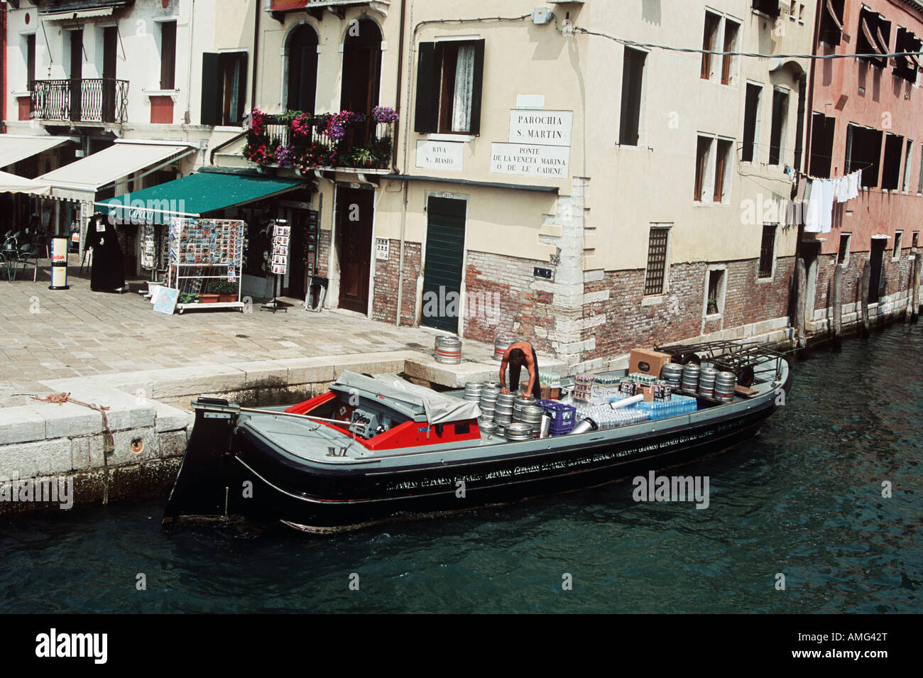Man on boat delivering beer in Venice, Italy Stock Photo Alamy