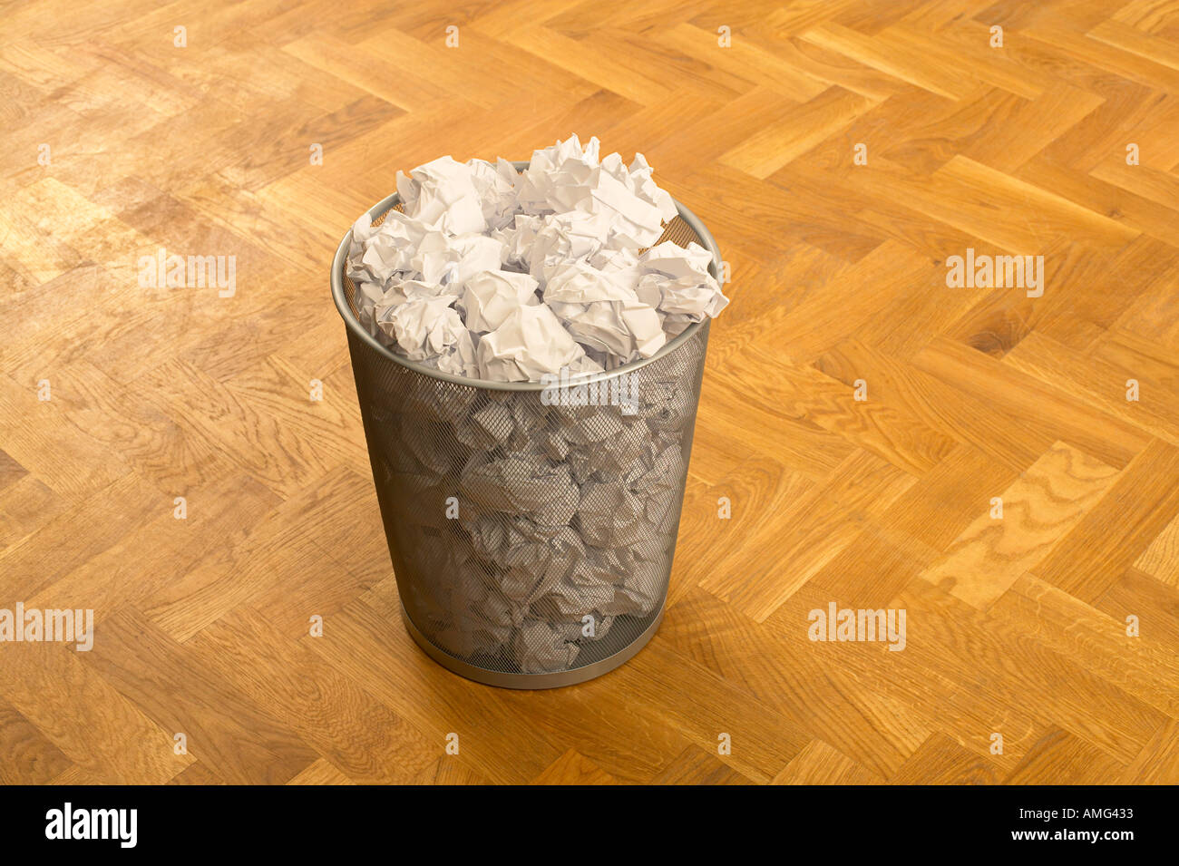 waste paper bin full of crunched up paper balls Stock Photo