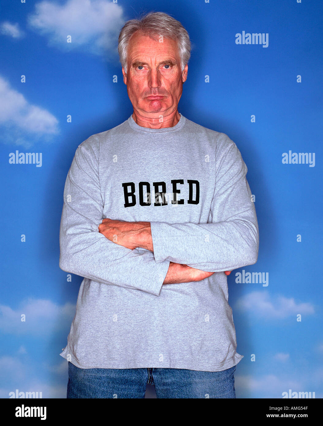 A Portrait of a mature man wearing a long sleeved T shirt against a blue sky background Stock Photo