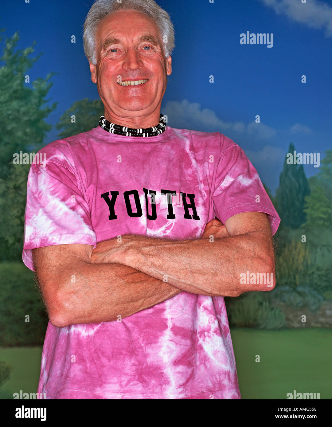 A portrait of a mature man wearing a T shirt against a garden background Stock Photo