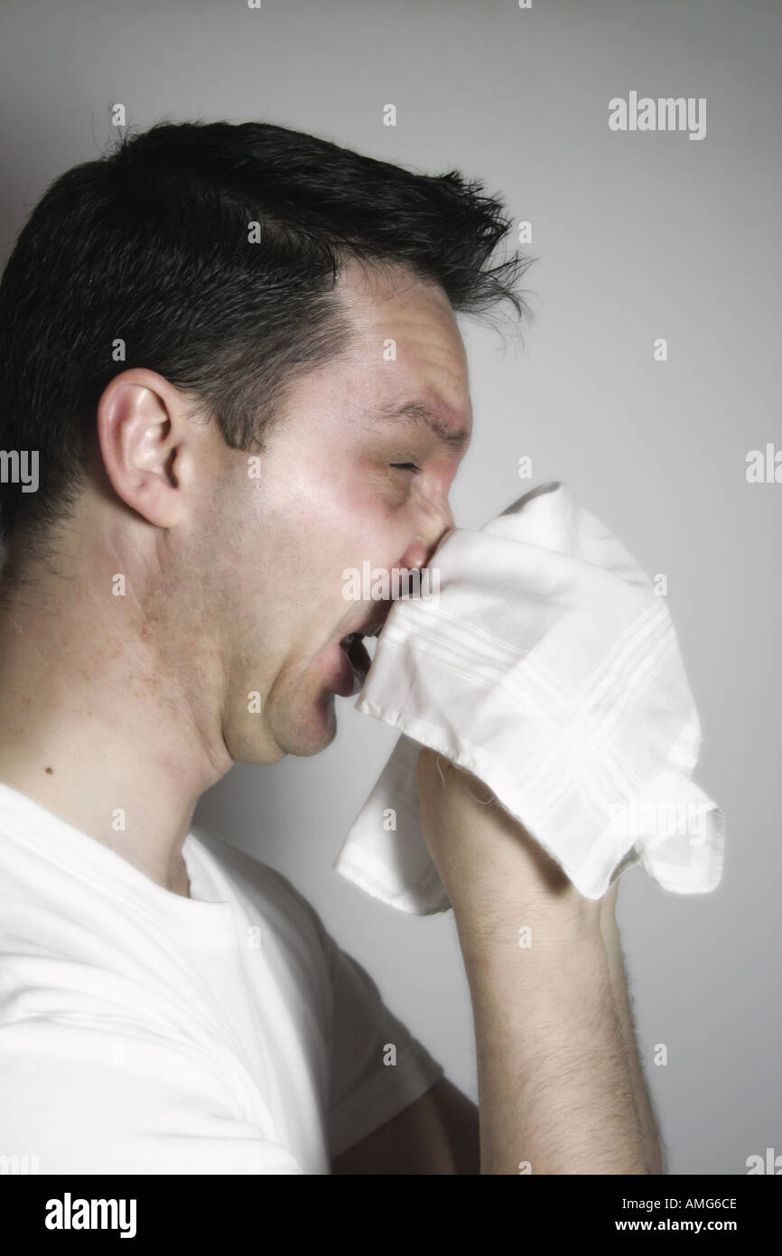 Man blowing his nose into a cotton handkerchief Stock Photo - Alamy