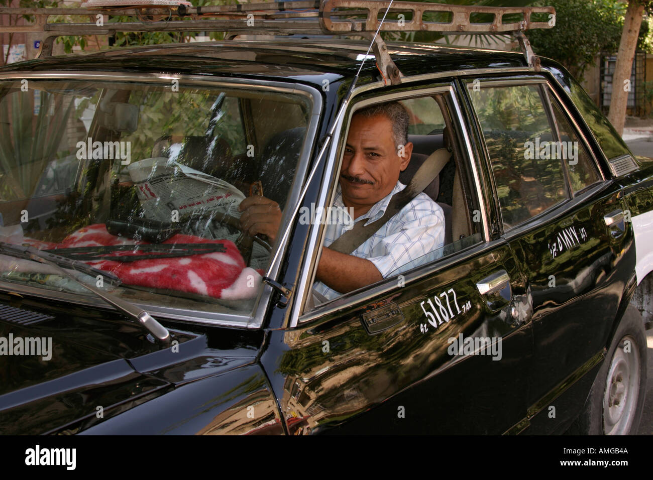 Egyptian taxi driver sitting in car Stock Photo Alamy