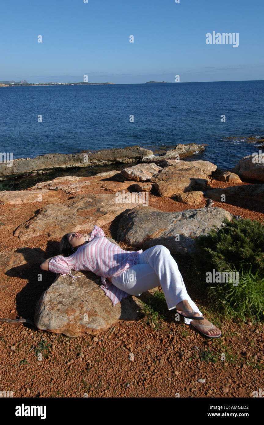Mixed race young woman half asian half spanish laying down relaxed on