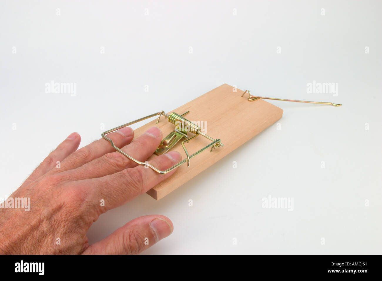 Male hand caught in mouse trap Stock Photo - Alamy