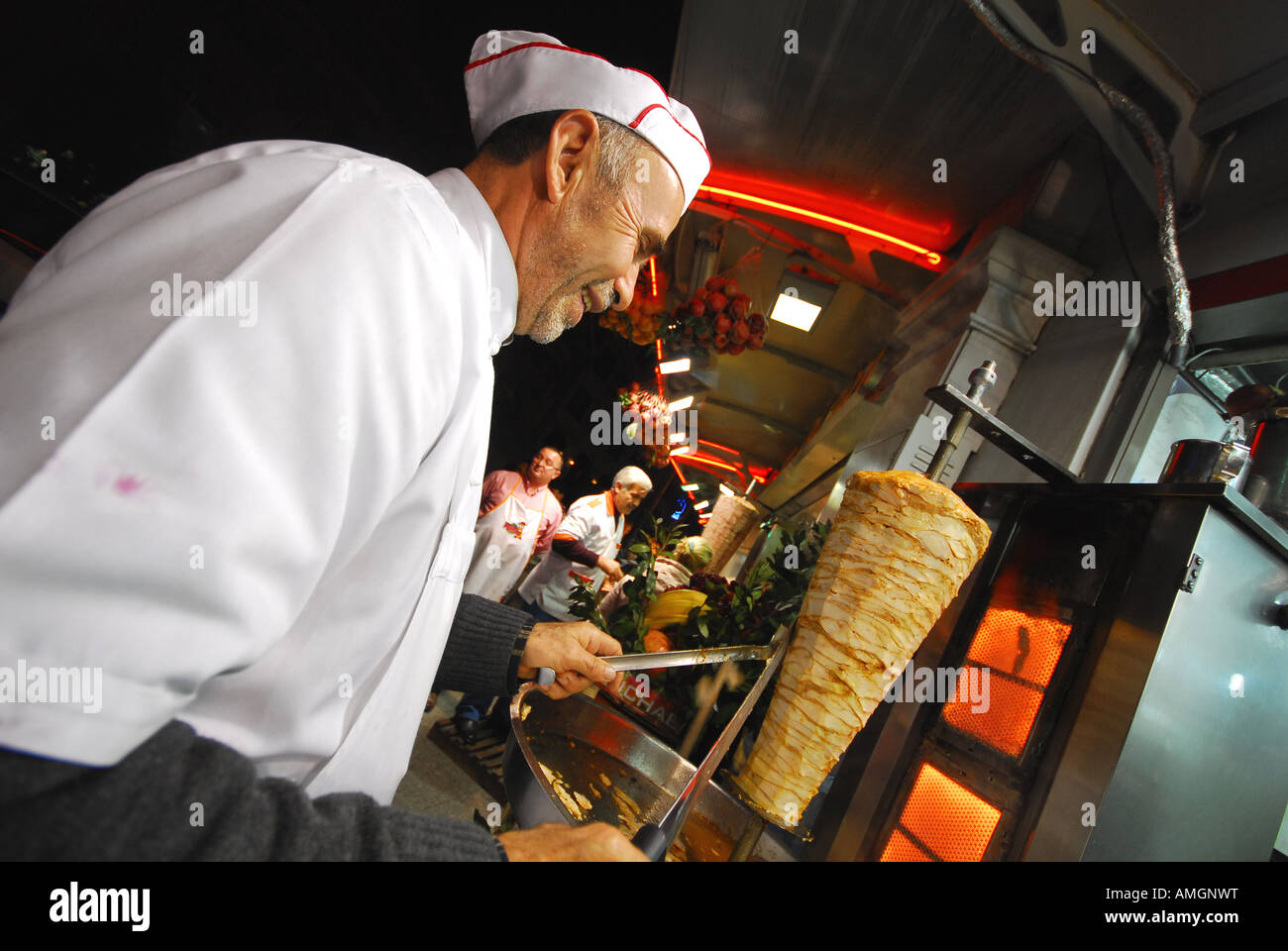 ISTANBUL Man carving lamb kebab at restaurant on Taksim Square at the