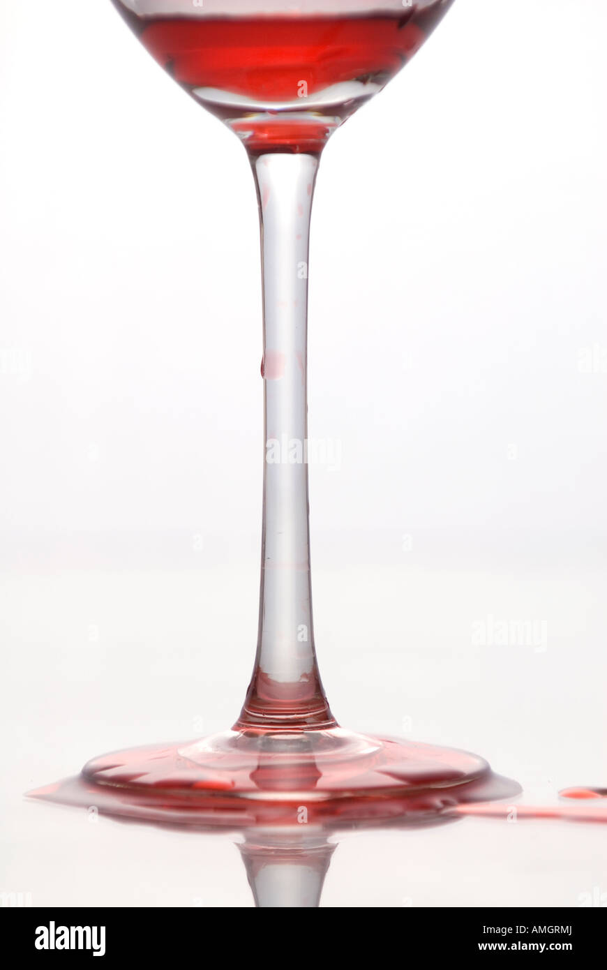 Close up of wine spilling out of glass Stock Photo