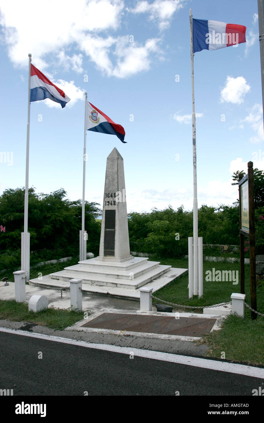 Roadside obelisk and national flags mark division between Dutch Sint Maarten and French Saint Martin Stock Photo