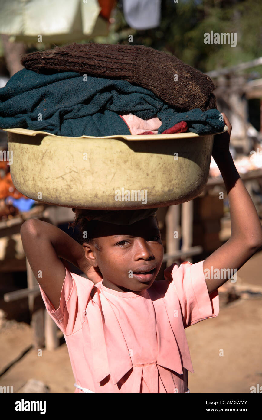 Young girl carrying bag on her head, Madagascar Stock Photo Alamy