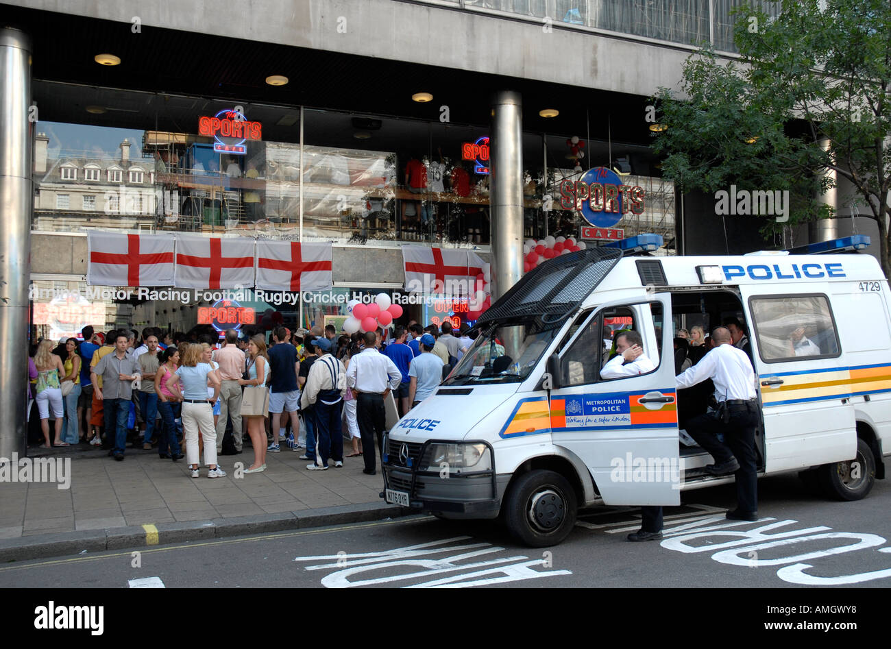 Police watching people watching a 2006 World Cup football match outside The Sports Café in Haymarket London Stock Photo