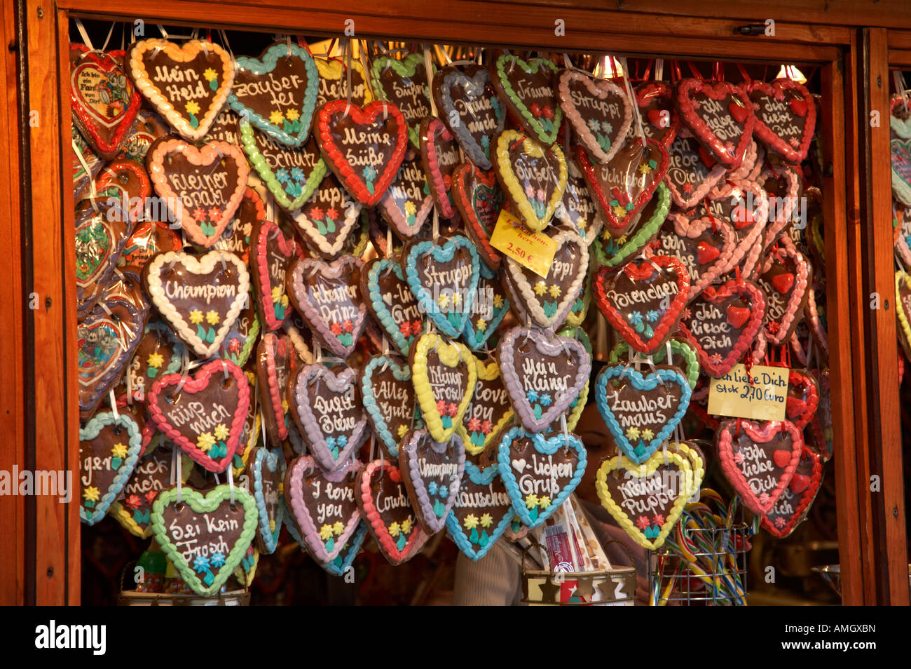 various Lebküchen gingerbread hearts hang for sale from a stall in the christmas market Berlin Germany Stock Photo
