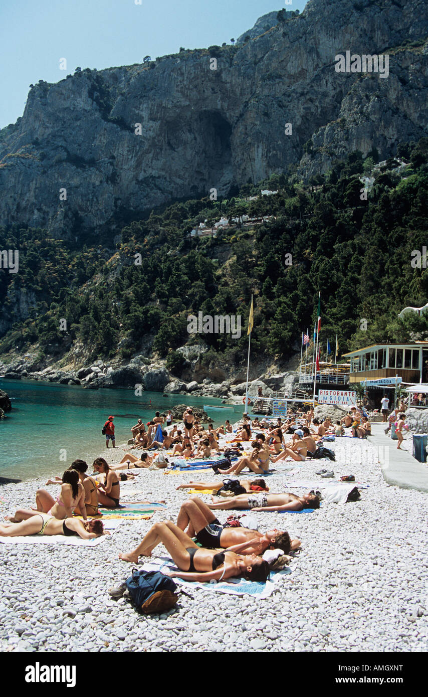 Tourists sunbathing on beach at Marina Piccola, Capri, Italy Stock