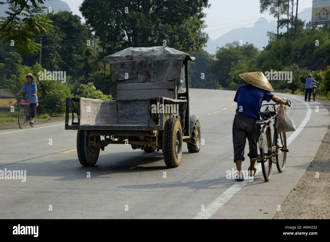 China Guangxi Near Yangshuo A Man Walking Beside His Bike On A Countryside  Road While A Tractor Is Passing Him Stock Photo - Alamy