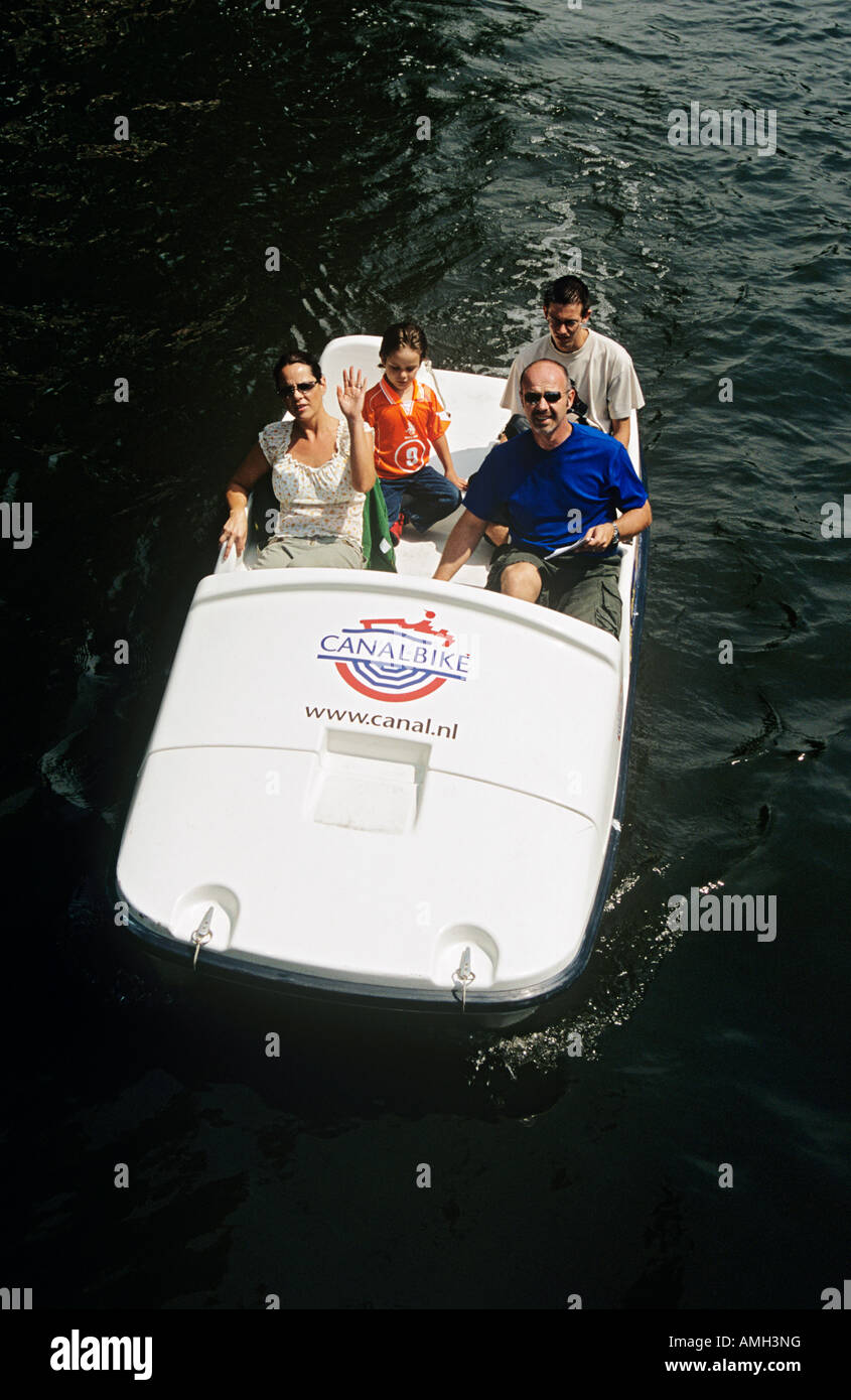 Tourists travelling in a pedalo canalbike on a canal, Amsterdam, Holland Stock Photo