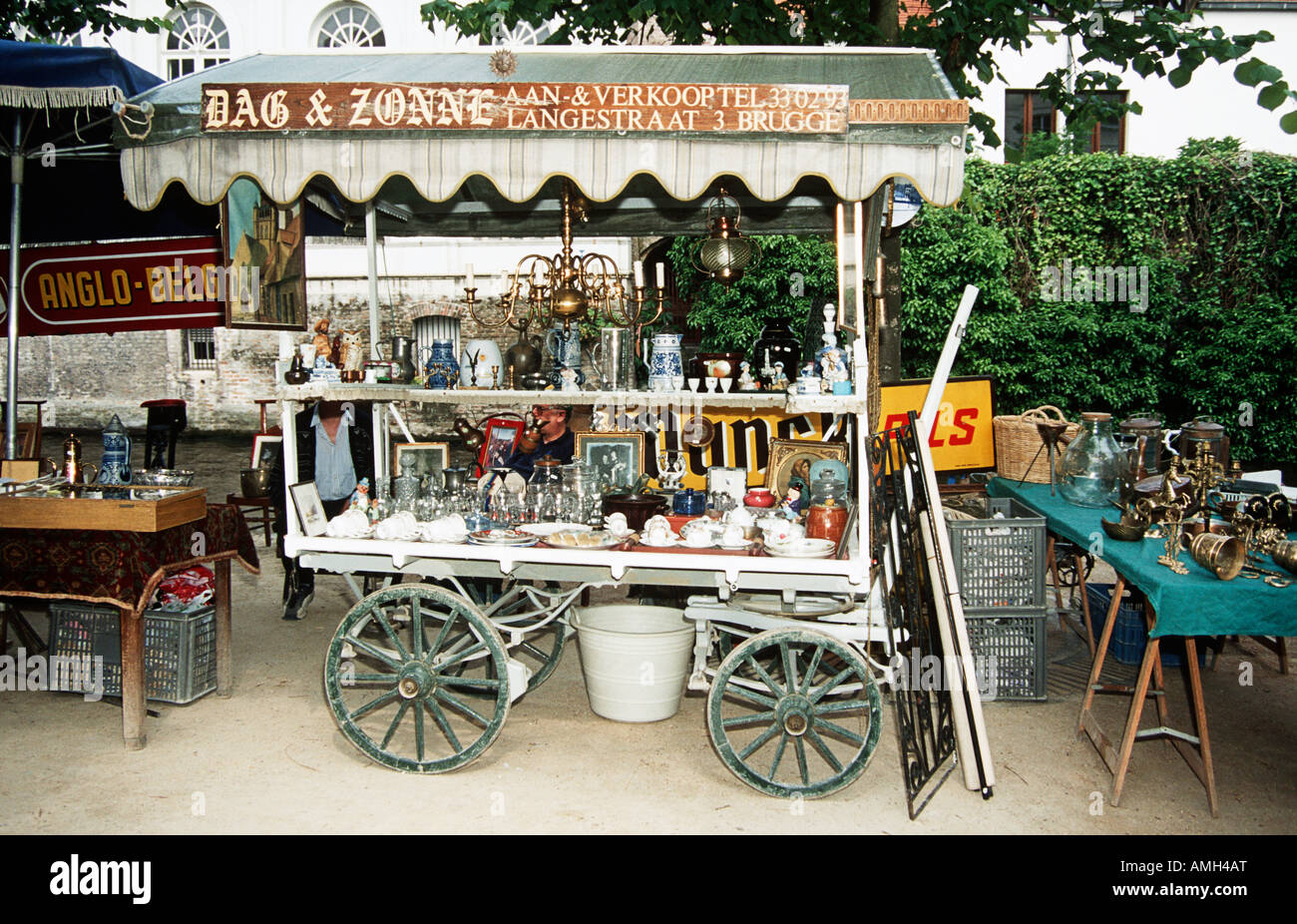 Antiques for sale on a cart on a pavement in a flea market, Bruges
