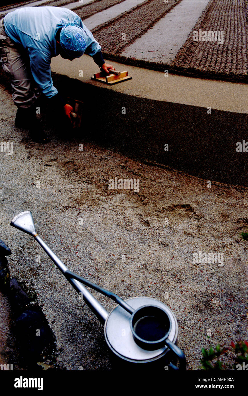 "Gardeners raking a new zen garden at Ginkakuji Silver Zen Garden Kyoto