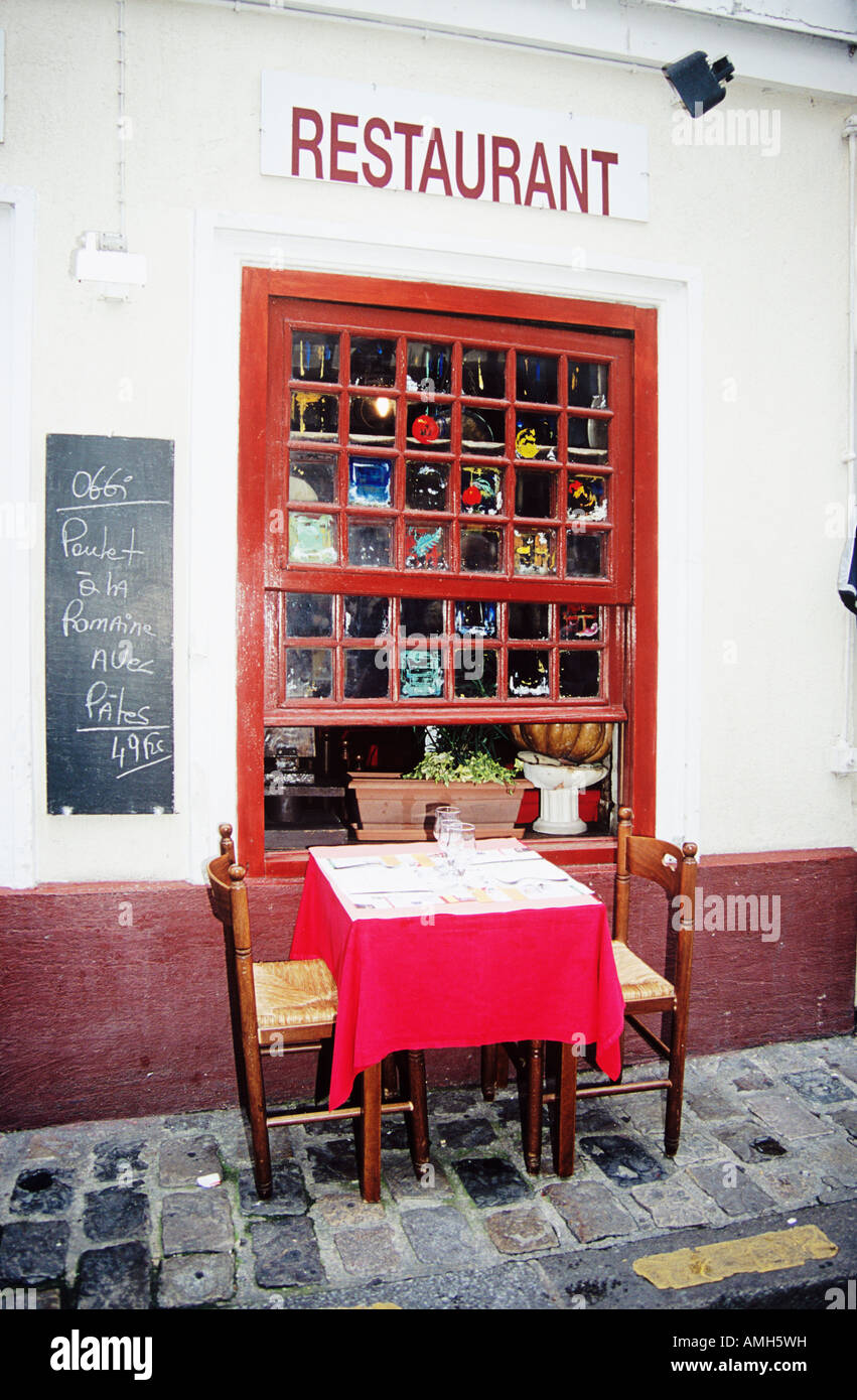 Table and chairs outside a restaurant, Montmartre District, Paris, France Stock Photo