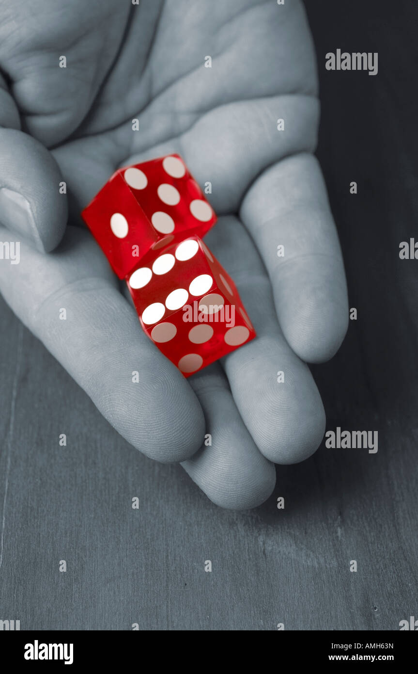 Man rolling pair of dice Stock Photo