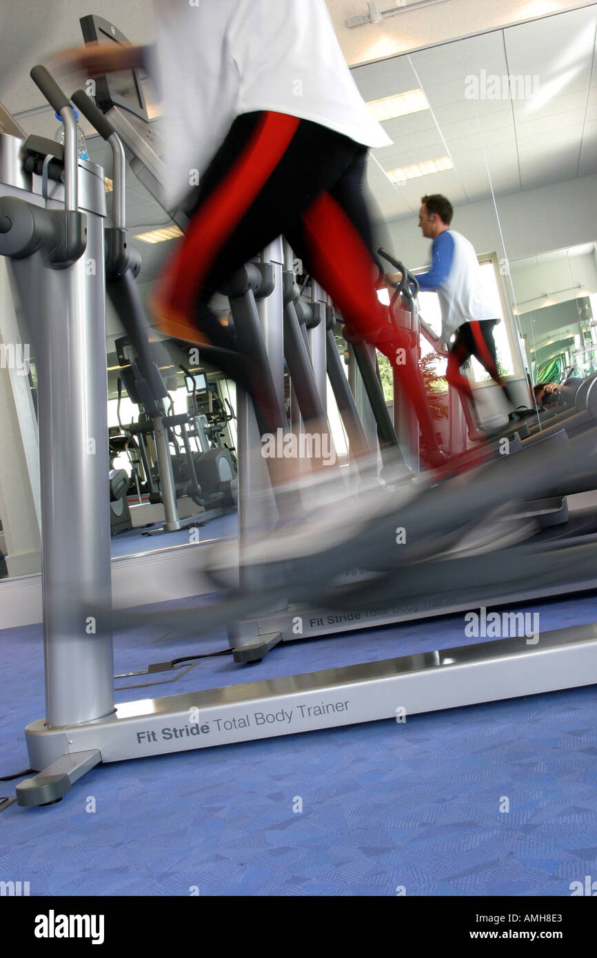 A man doing cardio execise on a  jogging machine at a gym Stock Photo