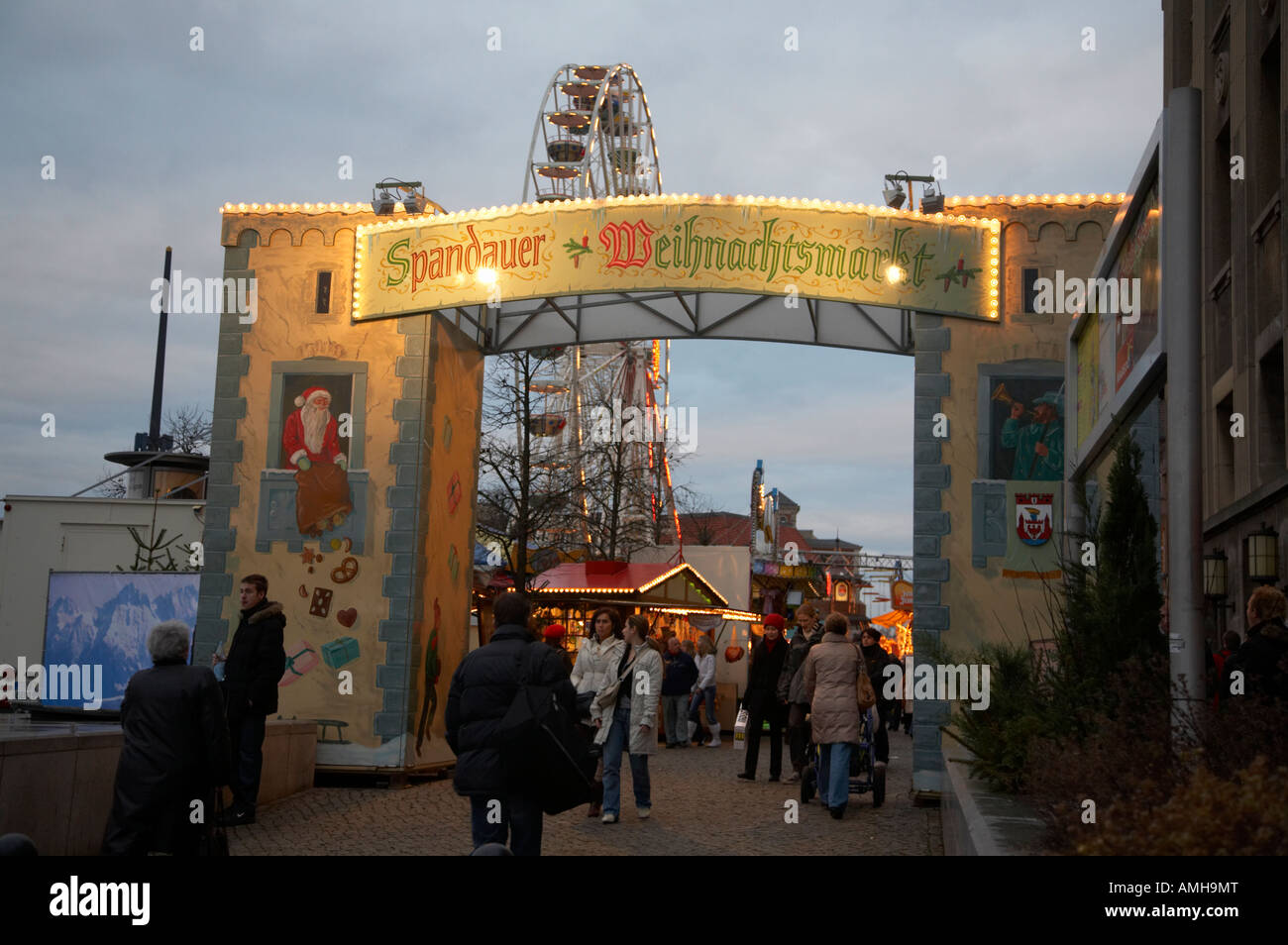 tourists walking through the entrance to the spandau christmas market Berlin Germany Stock Photo
