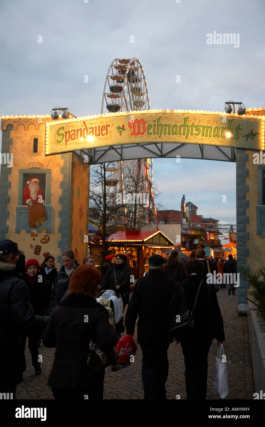 tourists walking through the entrance to the spandau christmas market Berlin Germany Stock Photo