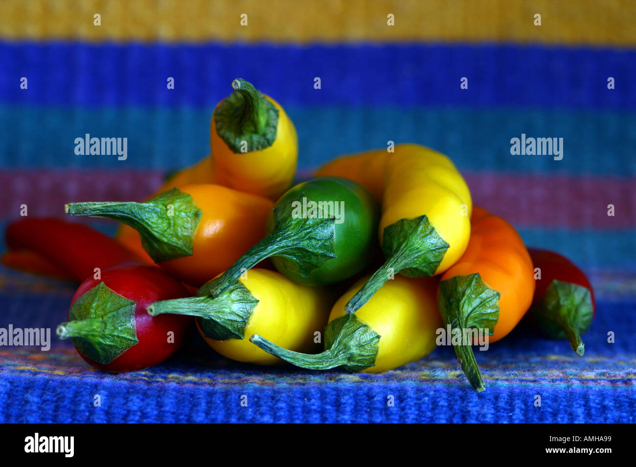 Yellow green and red chile peppers on a colorful cloth Stock Photo - Alamy
