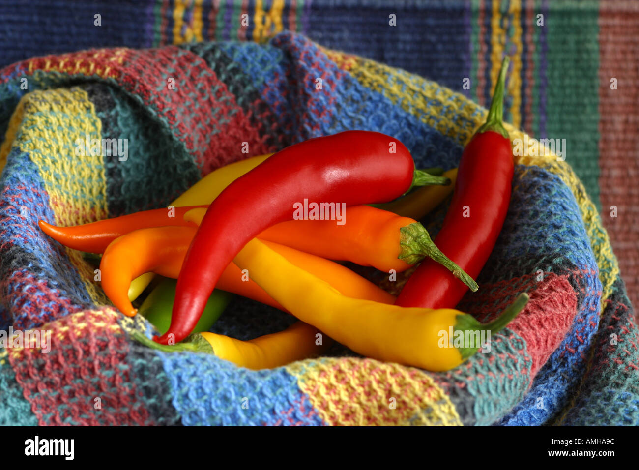 Yellow green and red chile peppers on a colorful cloth Stock Photo - Alamy