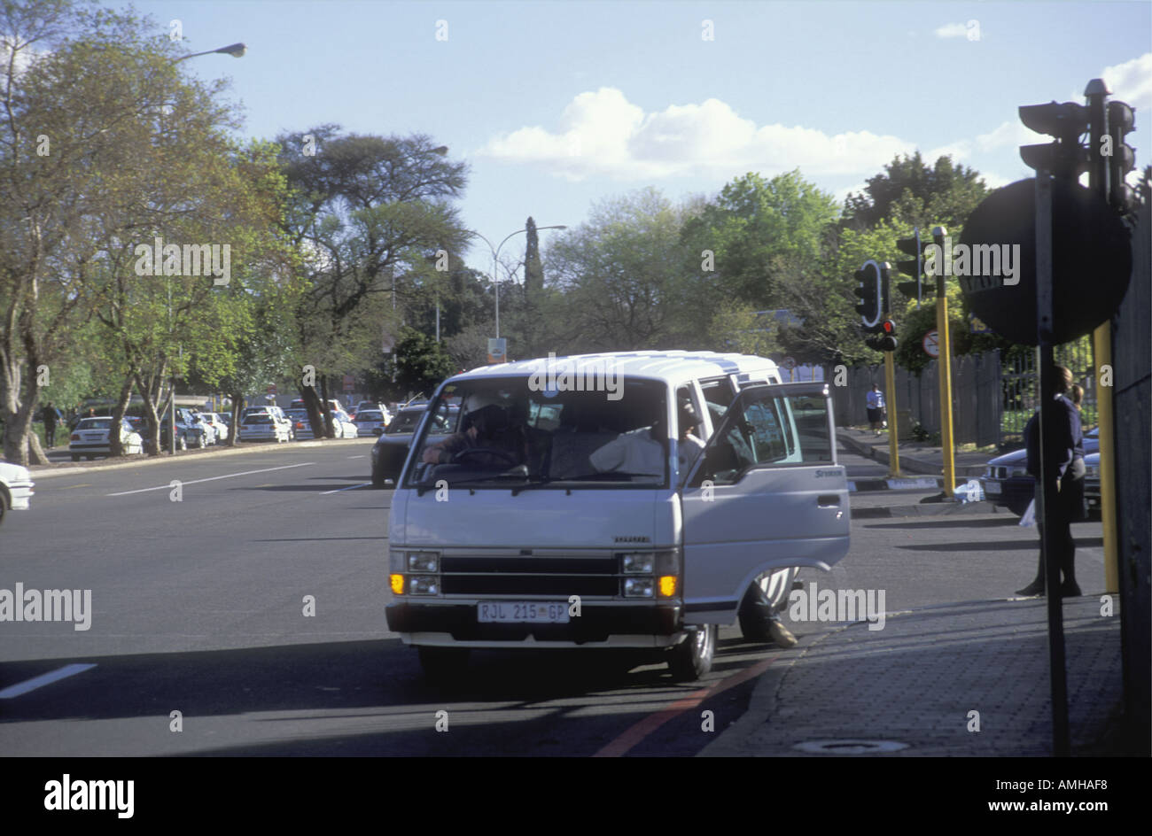Minibus style taxi stopping for passengers to alight at Sandton City shopping centre Johannesburg South Africa Stock Photo