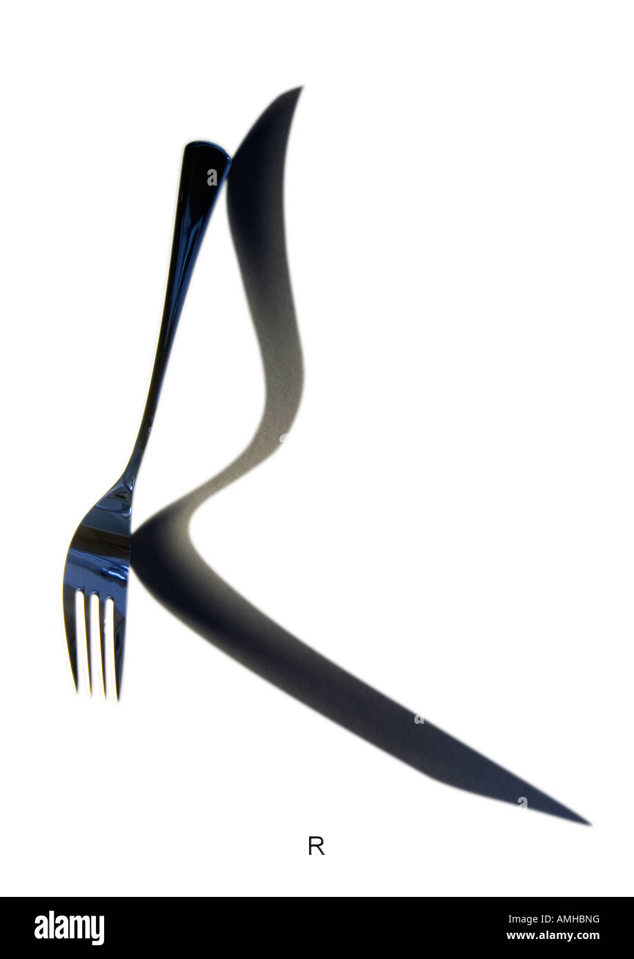 A fork with a hard shadow which when view abstractedly form the letter ...
