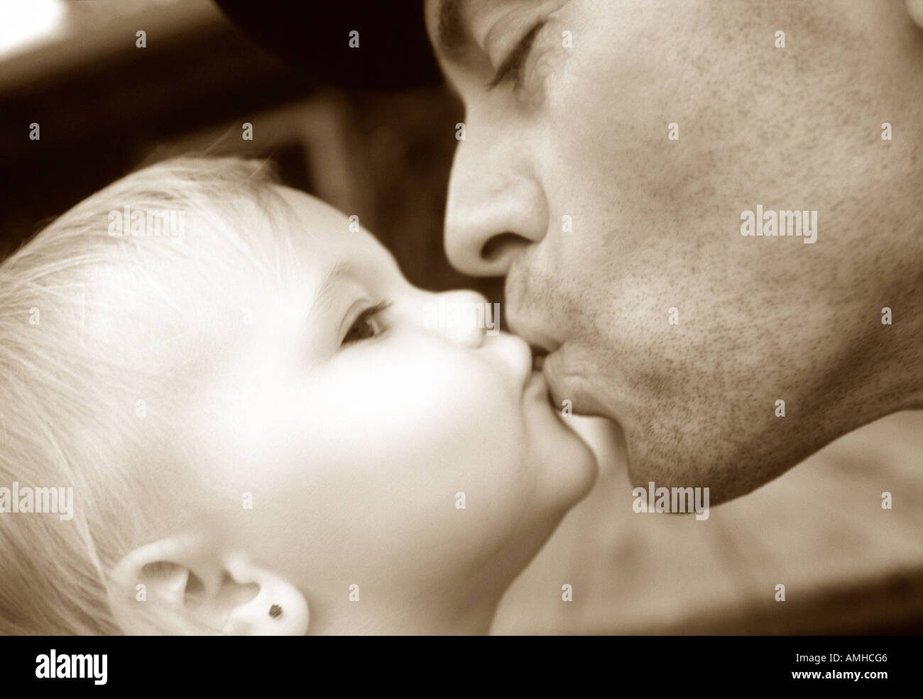Close-Up of Father Kissing Baby Stock Photo