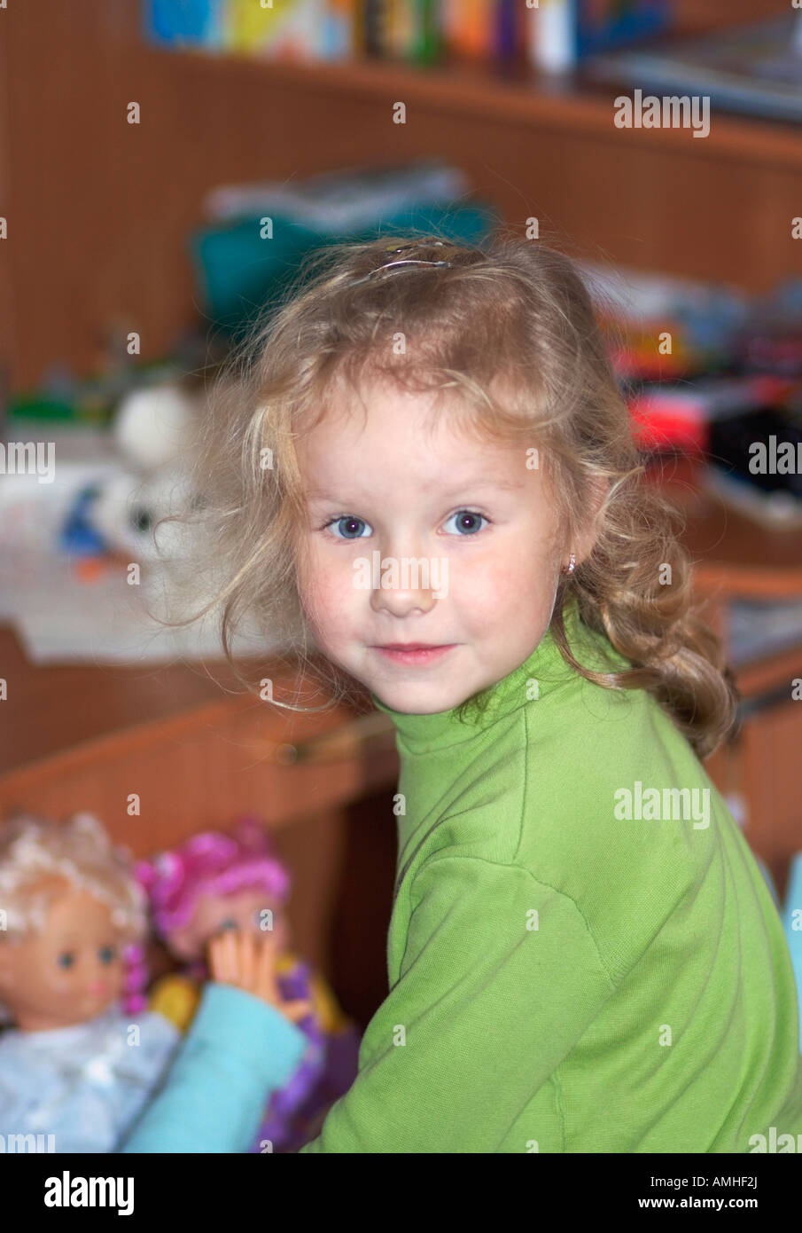 Small playing with dolls girl portret indoor Stock Photo - Alamy
