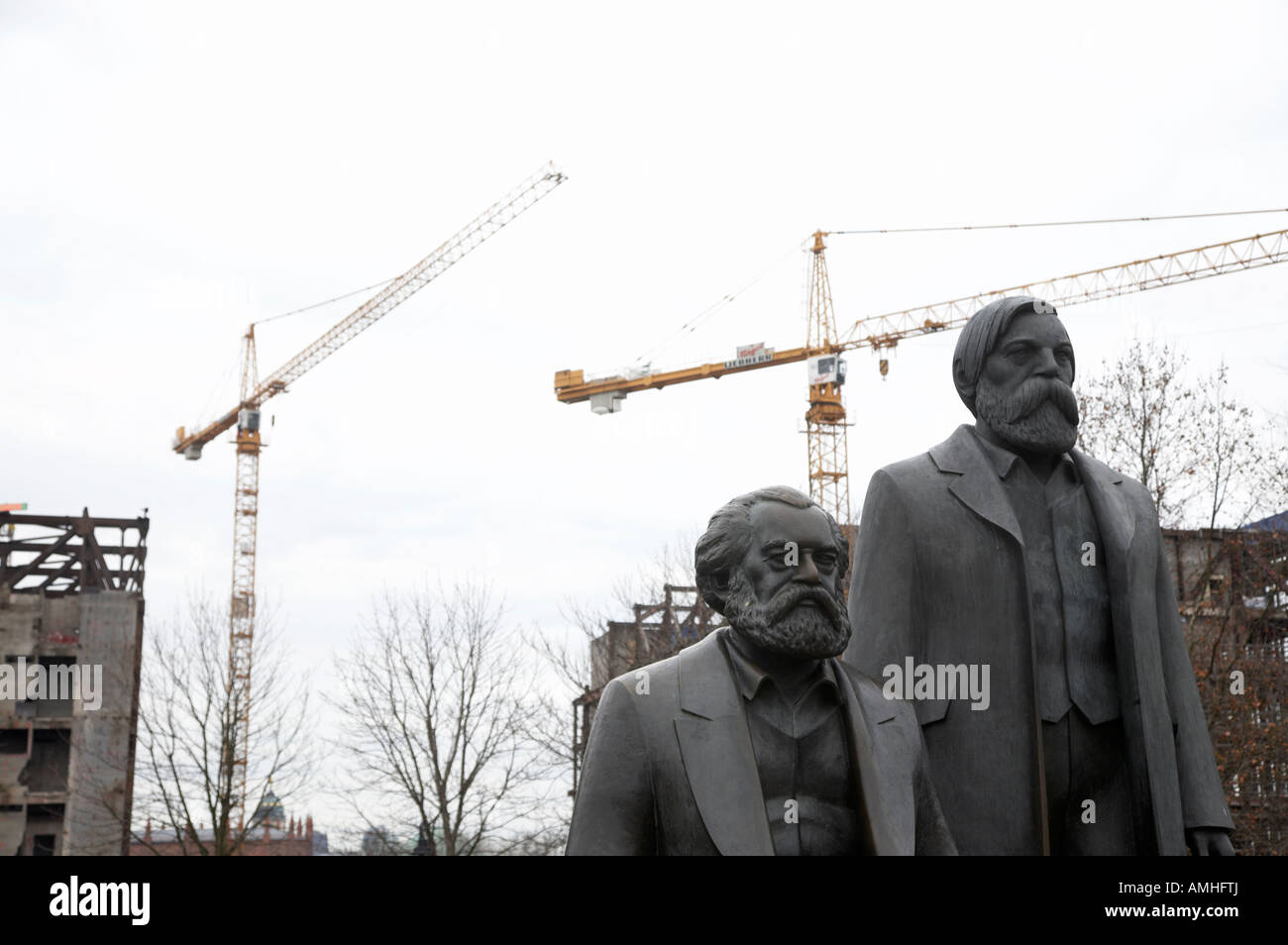 statues of marx and engels with deconstruction of the palast der republik in the background Berlin Germany Stock Photo
