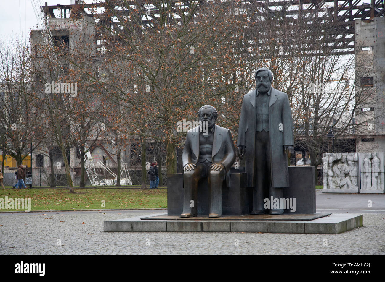 statues of marx and engels with deconstruction of the palast der republik in the background Berlin Germany Stock Photo