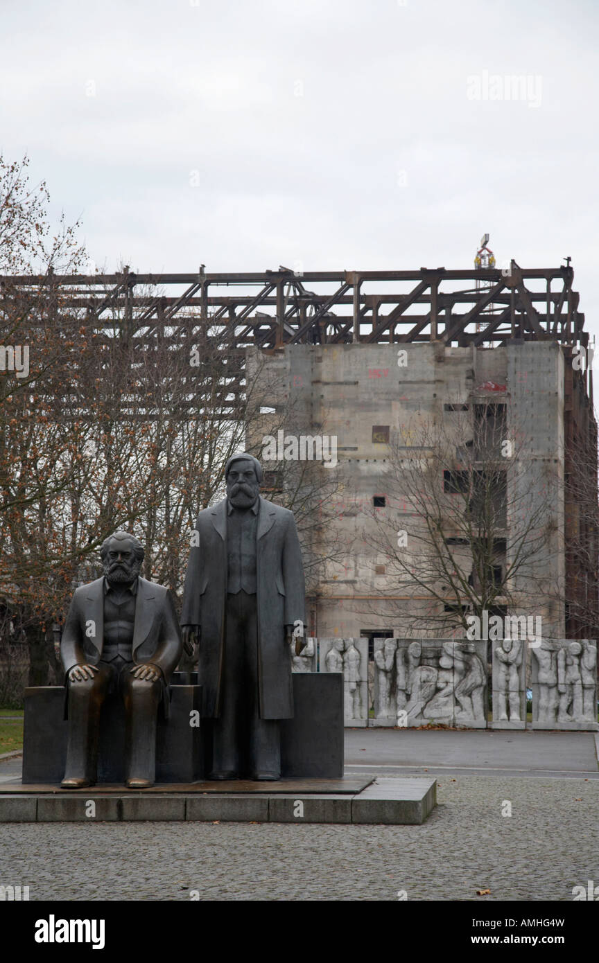 statues of marx and engels with deconstruction of the palast der republik in the background Berlin Germany Stock Photo