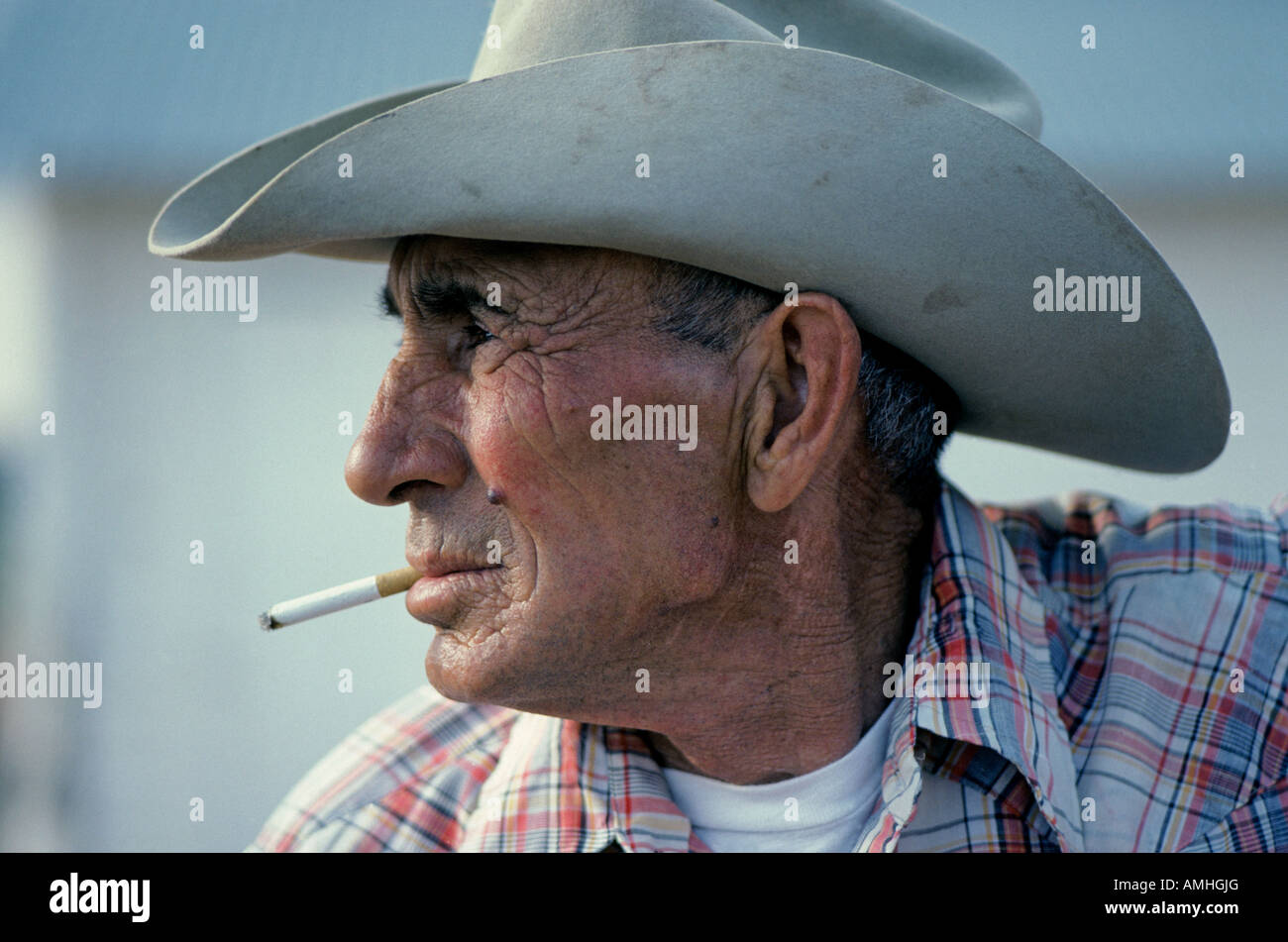 A ranch cowboy smoking a cigarette on a large cattle ranch near Post Texas Stock Photo