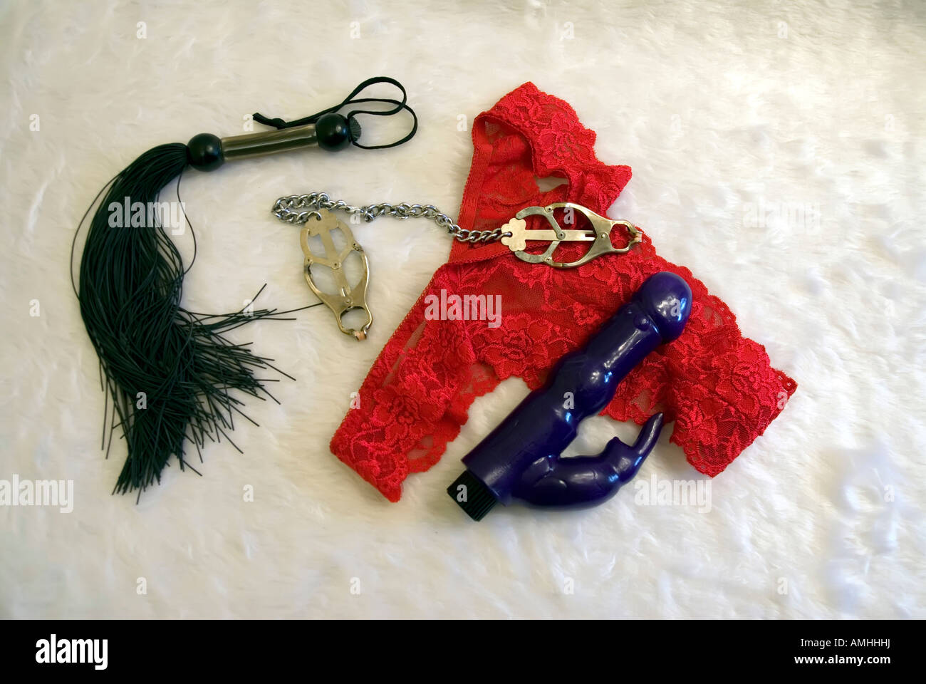 Red lacey thong underwear knickers small rubber whip vibrator nipple clamps  Stock Photo - Alamy