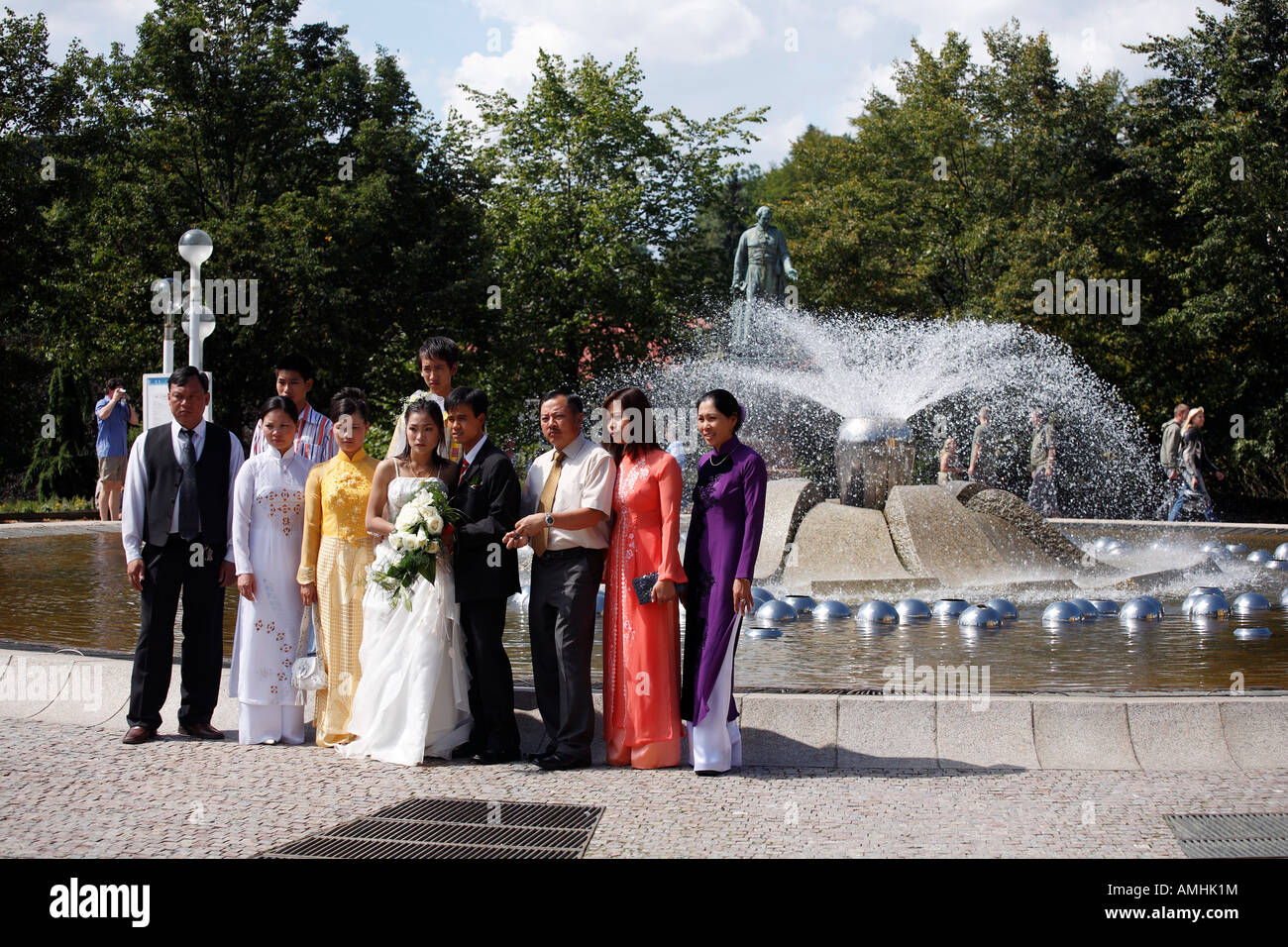 vietnamese wedding in front of the musical fountains in Marianske Lazne Czech republic Stock Photo