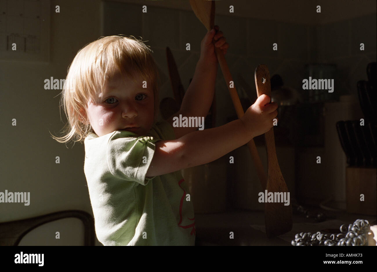 small child plays with wooden spoons  Stock Photo
