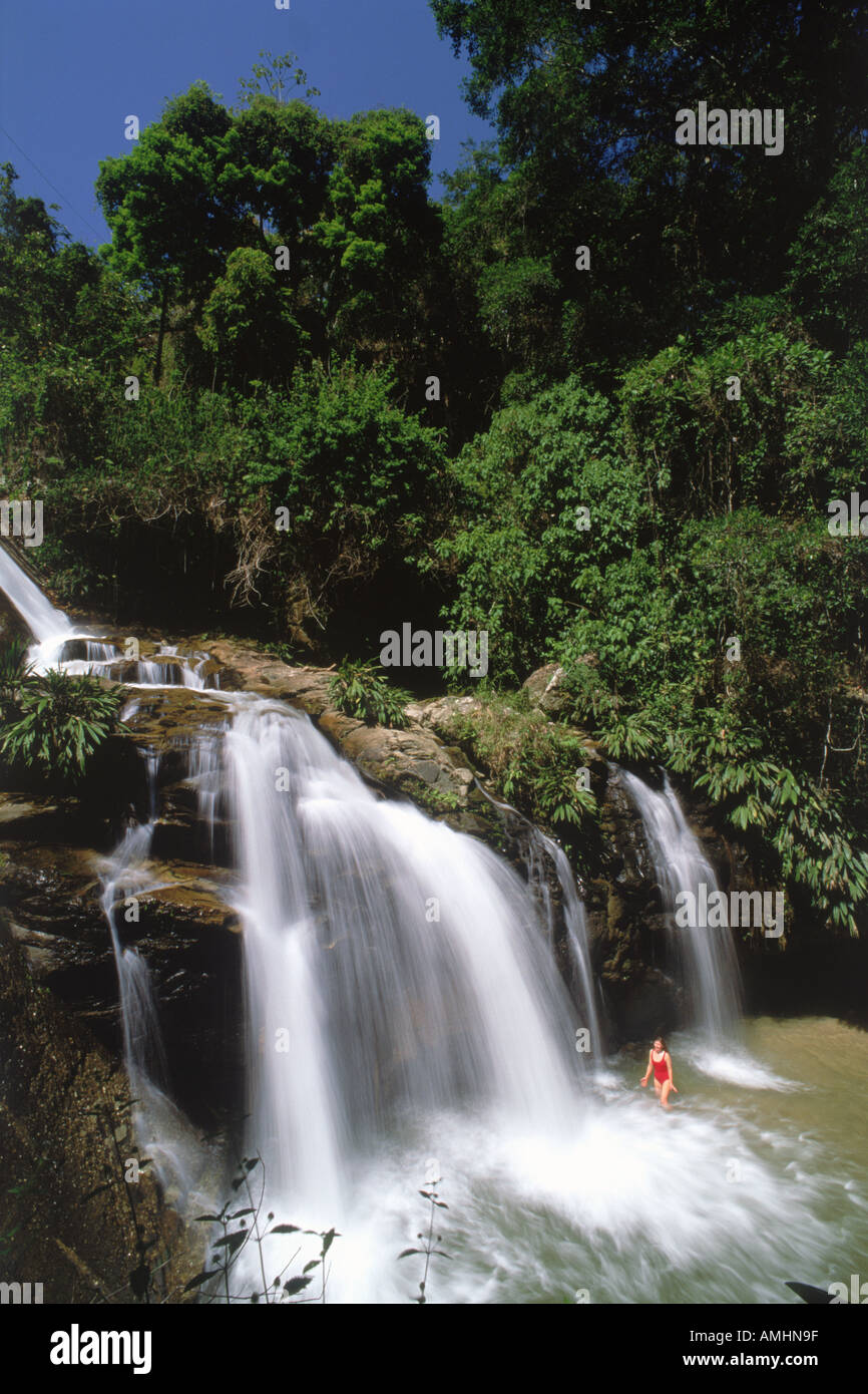 Woman below waterfall in La Gran Sabana Canaima National Park in Bolivar State Venezuela Stock Photo