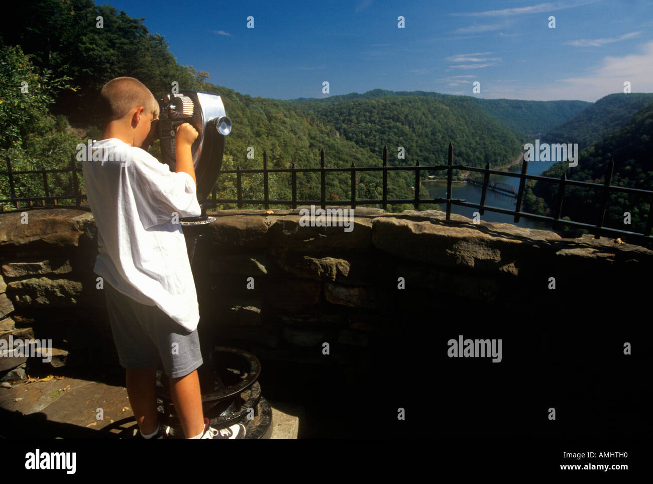 Boy tourist looking over Hawks Nest State Park Overlook on Scenic Highway US Route 60 on New River Ansted WV Stock Photo