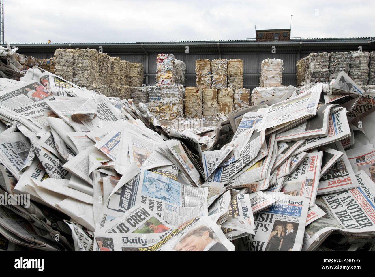 Pile of returned newspapers at paper recycling facility England UK Stock Photo