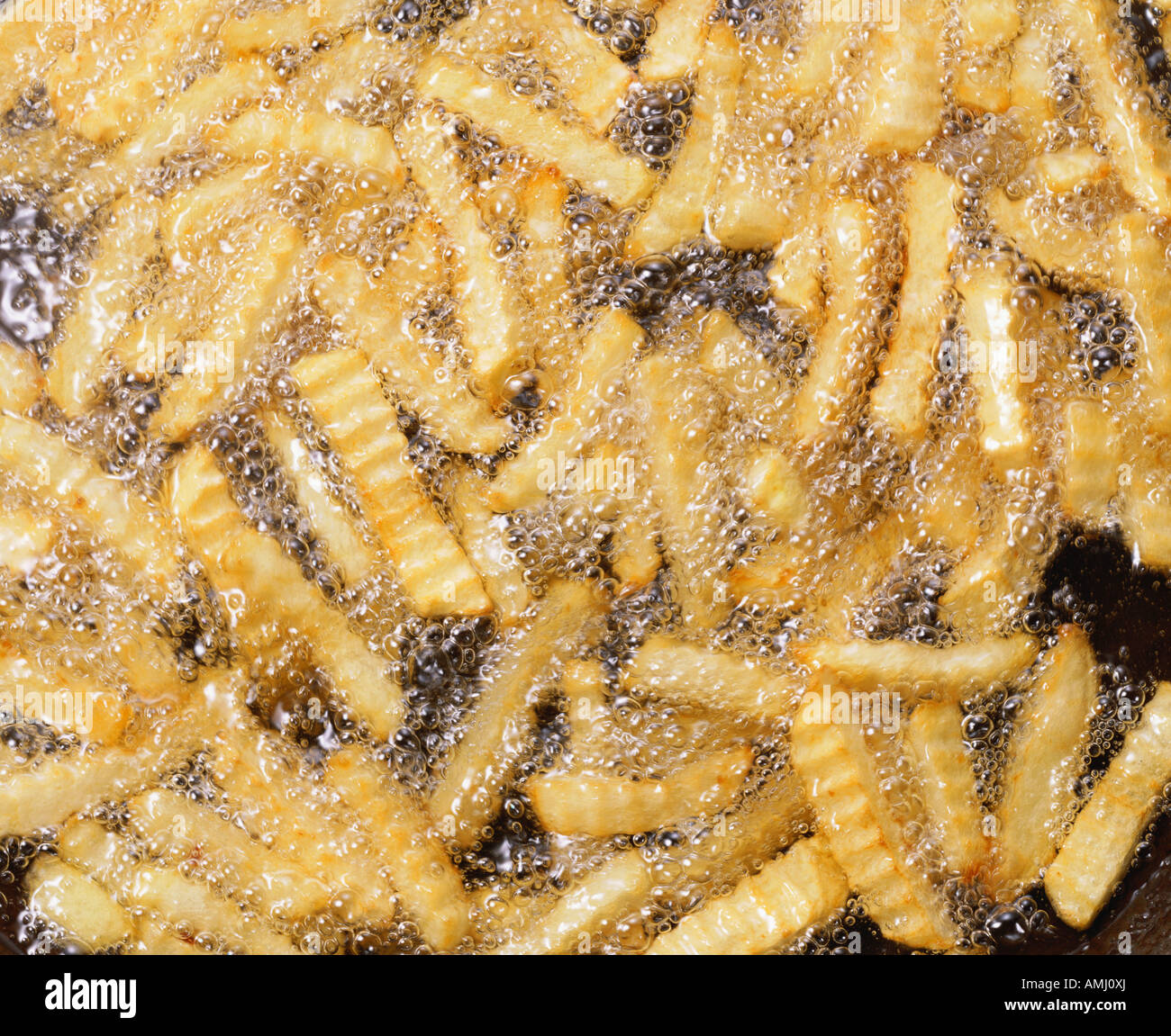 French fries frying in oil Stock Photo Alamy