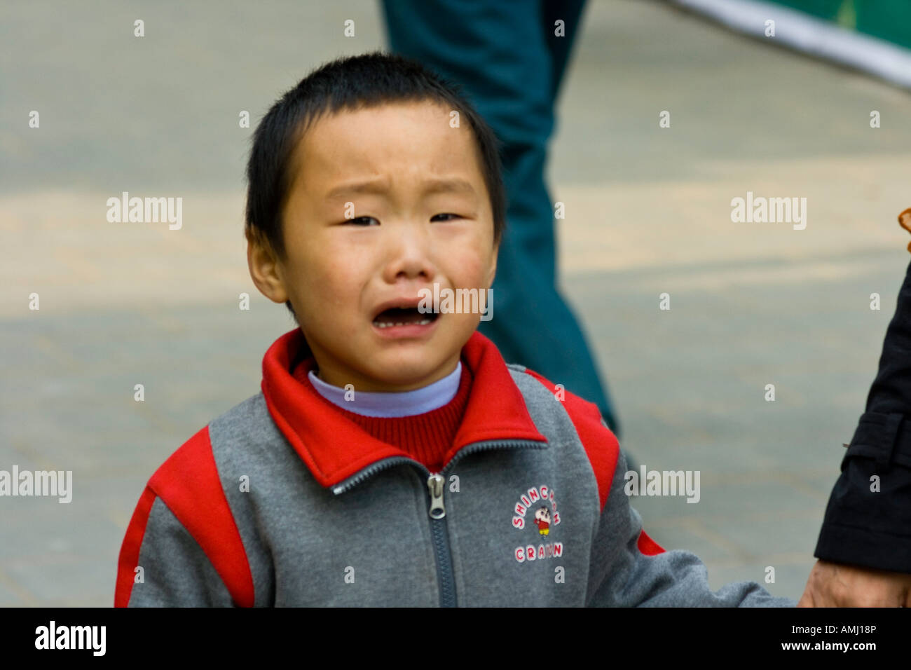 Young Chinese Boy Crying in Beijing China Stock Photo