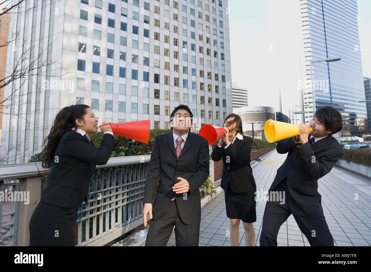 Group of business people shouting at colleague Stock Photo